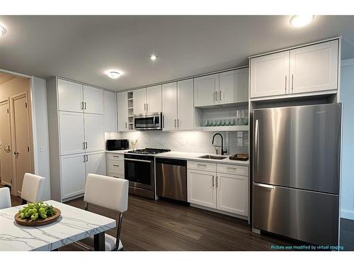 1313-350 Livingston Common Ne, Calgary, AB - Indoor Photo Showing Kitchen With Stainless Steel Kitchen With Upgraded Kitchen