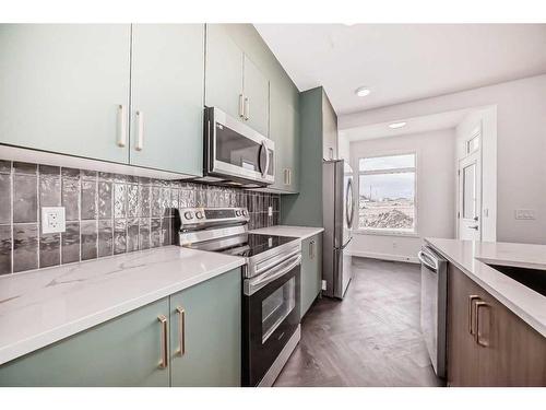 57 Shale Avenue, Cochrane, AB - Indoor Photo Showing Kitchen With Upgraded Kitchen