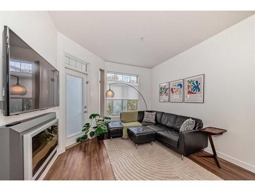 110-16 Auburn Bay Link Se, Calgary, AB - Indoor Photo Showing Living Room With Fireplace