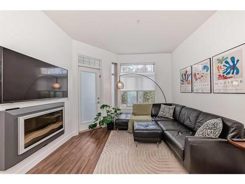 110-16 Auburn Bay Link Se, Calgary, AB - Indoor Photo Showing Living Room With Fireplace