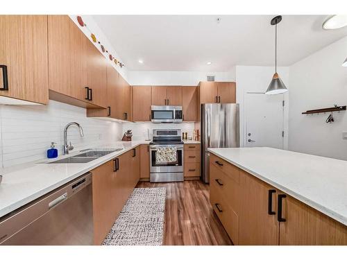 110-16 Auburn Bay Link Se, Calgary, AB - Indoor Photo Showing Kitchen With Stainless Steel Kitchen With Double Sink With Upgraded Kitchen