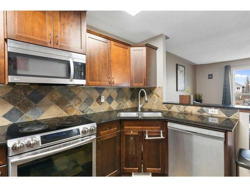 168 Bayside Point Sw, Airdrie, AB - Indoor Photo Showing Kitchen With Double Sink