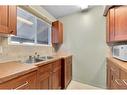 802-2520 Palliser Drive Sw, Calgary, AB  - Indoor Photo Showing Kitchen With Double Sink 