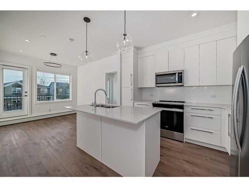 4211-111 Wolf Creek Drive Se, Calgary, AB - Indoor Photo Showing Kitchen With Stainless Steel Kitchen With Double Sink With Upgraded Kitchen