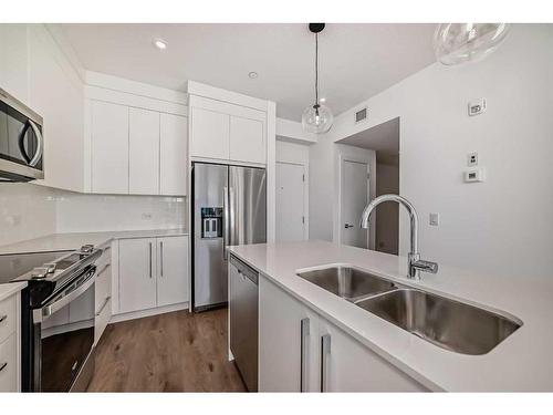 4211-111 Wolf Creek Drive Se, Calgary, AB - Indoor Photo Showing Kitchen With Stainless Steel Kitchen With Double Sink With Upgraded Kitchen