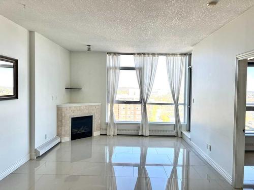 1701-55 Spruce Place Sw, Calgary, AB - Indoor Photo Showing Other Room With Fireplace