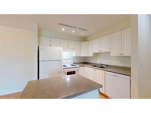 312-4000 Somervale Court Sw, Calgary, AB - Indoor Photo Showing Kitchen With Double Sink