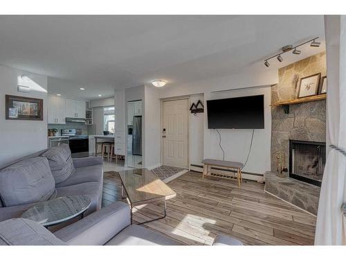 6-713 Mcdougall Road Ne, Calgary, AB - Indoor Photo Showing Living Room With Fireplace