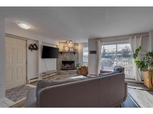 6-713 Mcdougall Road Ne, Calgary, AB - Indoor Photo Showing Living Room With Fireplace