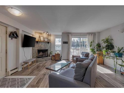 6-713 Mcdougall Road Ne, Calgary, AB - Indoor Photo Showing Living Room With Fireplace