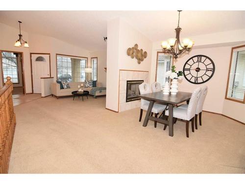 274 Hamptons Park Nw, Calgary, AB - Indoor Photo Showing Dining Room With Fireplace