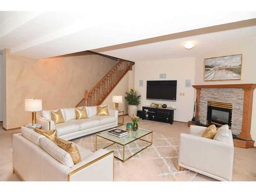 274 Hamptons Park Nw, Calgary, AB - Indoor Photo Showing Living Room With Fireplace