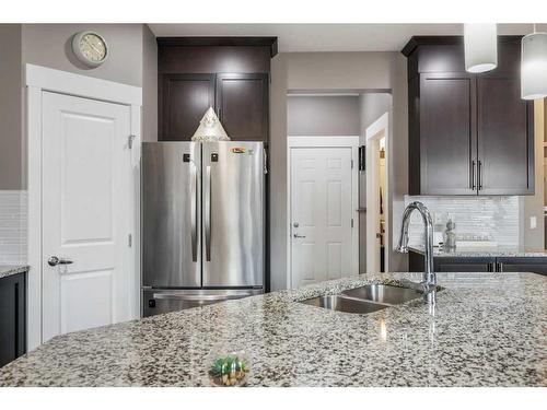 208 Rainbow Falls Green, Chestermere, AB - Indoor Photo Showing Kitchen With Double Sink With Upgraded Kitchen