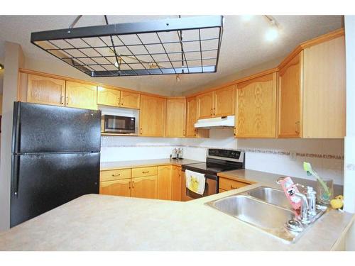 177 Hidden Ranch Road Nw, Calgary, AB - Indoor Photo Showing Kitchen With Double Sink