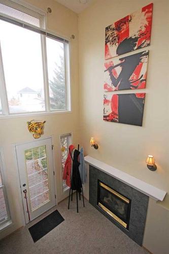 177 Hidden Ranch Road Nw, Calgary, AB - Indoor Photo Showing Other Room With Fireplace