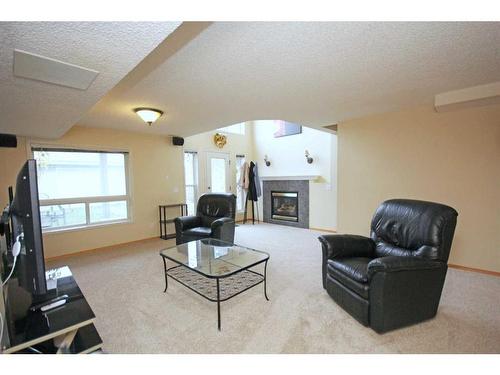 177 Hidden Ranch Road Nw, Calgary, AB - Indoor Photo Showing Living Room With Fireplace