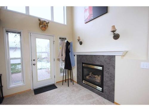 177 Hidden Ranch Road Nw, Calgary, AB - Indoor Photo Showing Living Room With Fireplace