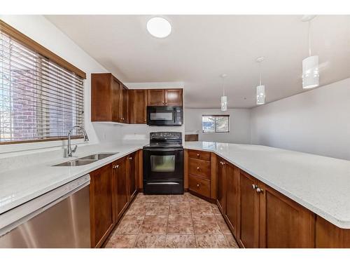 2126-10 Prestwick Bay Se, Calgary, AB - Indoor Photo Showing Kitchen With Double Sink