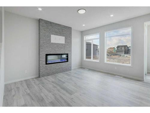 67 Corner Glen Common Ne, Calgary, AB - Indoor Photo Showing Living Room With Fireplace