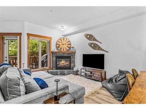 107-155 Crossbow Place, Canmore, AB - Indoor Photo Showing Living Room With Fireplace