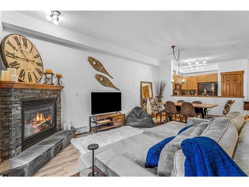 107-155 Crossbow Place, Canmore, AB - Indoor Photo Showing Living Room With Fireplace