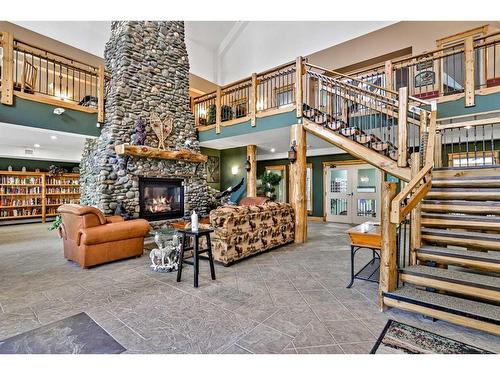 107-155 Crossbow Place, Canmore, AB - Indoor Photo Showing Other Room With Fireplace