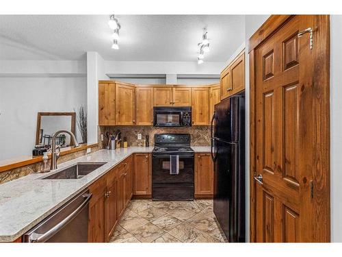 107-155 Crossbow Place, Canmore, AB - Indoor Photo Showing Kitchen