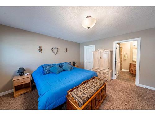 520 Harrison Court, Crossfield, AB - Indoor Photo Showing Bedroom