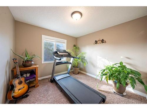 520 Harrison Court, Crossfield, AB - Indoor Photo Showing Gym Room