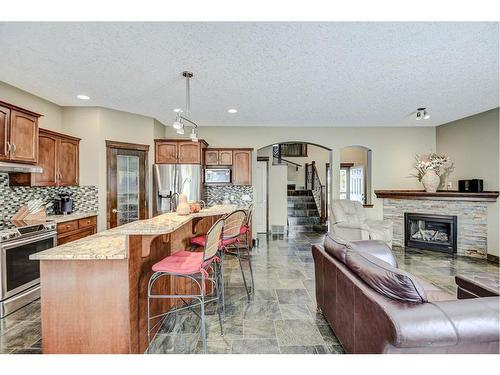 57 Eversyde Manor Sw, Calgary, AB - Indoor Photo Showing Kitchen With Fireplace With Stainless Steel Kitchen With Upgraded Kitchen