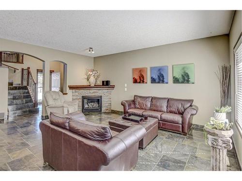 57 Eversyde Manor Sw, Calgary, AB - Indoor Photo Showing Living Room With Fireplace