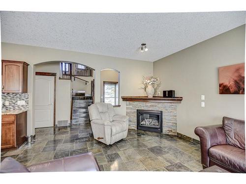 57 Eversyde Manor Sw, Calgary, AB - Indoor Photo Showing Living Room With Fireplace