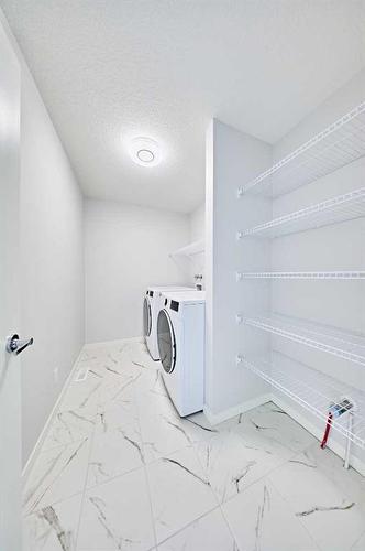 67 Seton Villas Se, Calgary, AB - Indoor Photo Showing Laundry Room