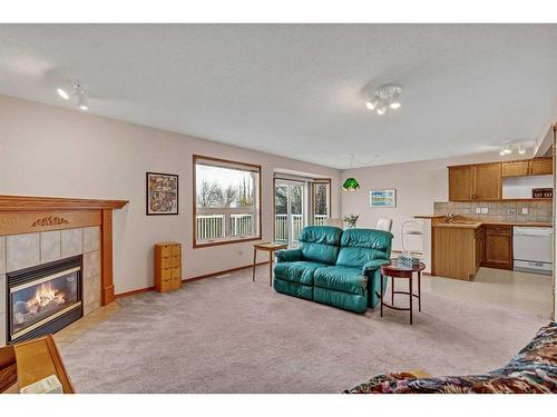 173 Coral Springs Court Ne, Calgary, AB - Indoor Photo Showing Living Room With Fireplace