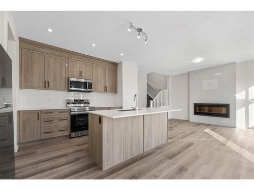 91 Cityline Heath Ne, Calgary, AB - Indoor Photo Showing Kitchen With Fireplace