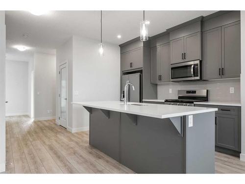 18 Amblefield Passage Nw, Calgary, AB - Indoor Photo Showing Kitchen With Upgraded Kitchen