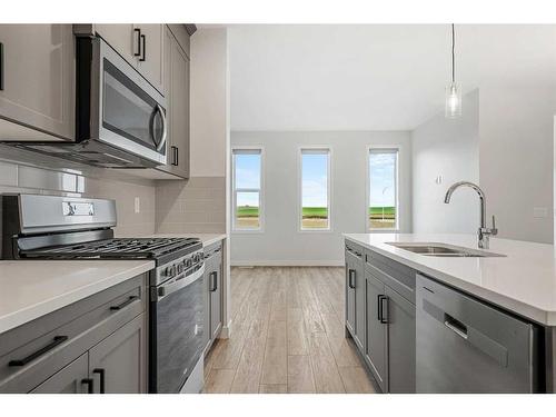 18 Amblefield Passage Nw, Calgary, AB - Indoor Photo Showing Kitchen With Double Sink