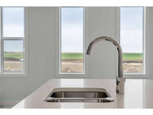 18 Amblefield Passage Nw, Calgary, AB - Indoor Photo Showing Kitchen With Double Sink