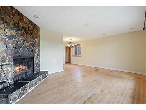 5728 Layzell Road Sw, Calgary, AB - Indoor Photo Showing Living Room With Fireplace