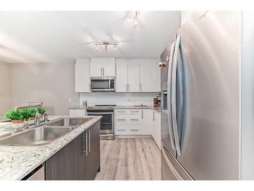 0037463783-133 Sage Hill Grove Nw, Calgary, AB - Indoor Photo Showing Kitchen With Stainless Steel Kitchen With Double Sink With Upgraded Kitchen