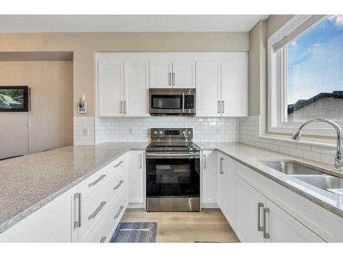 9 Masters Street Se, Calgary, AB - Indoor Photo Showing Kitchen With Double Sink