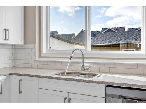 9 Masters Street Se, Calgary, AB - Indoor Photo Showing Kitchen With Double Sink