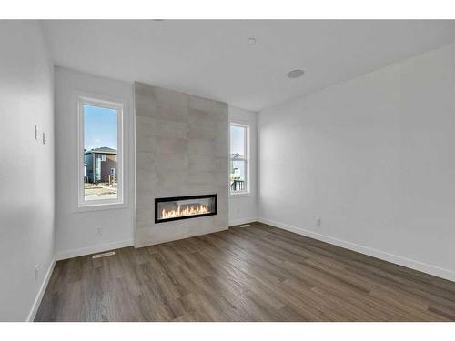 283 Hotchkiss Manor, Calgary, AB - Indoor Photo Showing Living Room With Fireplace