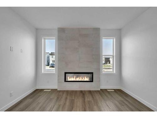 283 Hotchkiss Manor, Calgary, AB - Indoor Photo Showing Living Room With Fireplace