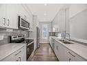 207 Evanscrest Square Nw, Calgary, AB  - Indoor Photo Showing Kitchen With Stainless Steel Kitchen With Double Sink With Upgraded Kitchen 