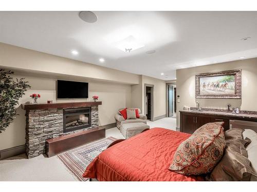 178068 112 Street, De Winton, AB - Indoor Photo Showing Bedroom With Fireplace