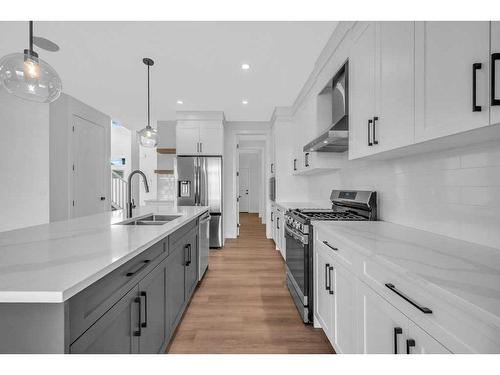 51 Heritage Circle, Cochrane, AB - Indoor Photo Showing Kitchen With Double Sink With Upgraded Kitchen