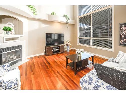 109 Everglade Circle Sw, Calgary, AB - Indoor Photo Showing Living Room With Fireplace