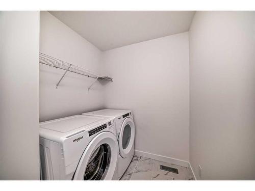 1038 Thimbleberry Hill Sw, Airdrie, AB - Indoor Photo Showing Laundry Room