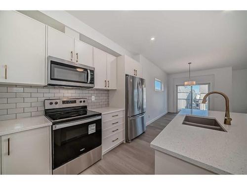 1038 Thimbleberry Hill Sw, Airdrie, AB - Indoor Photo Showing Kitchen With Double Sink With Upgraded Kitchen